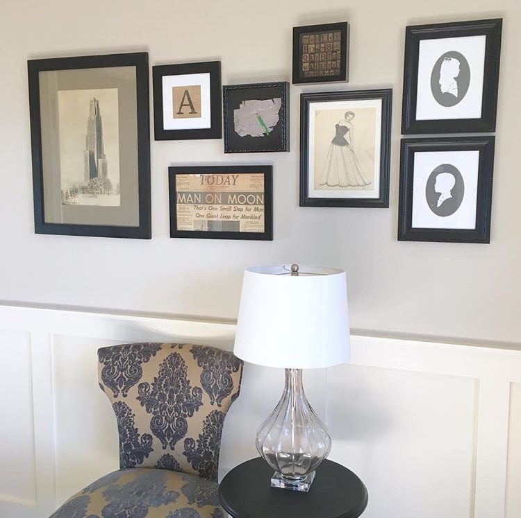 sitting space with white walls and picture frames