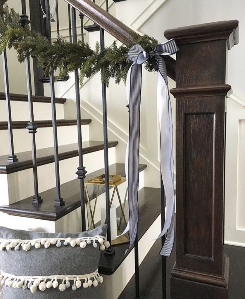 staircase wrapped with garland