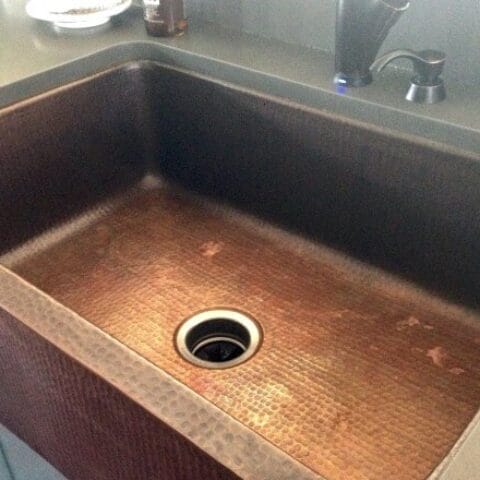 the basin of a copper kitchen sink