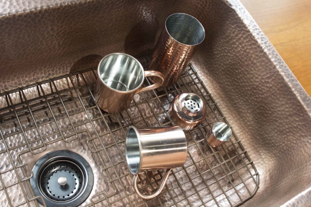 rohe bottom grid in angelico copper drop-in sink with dishes