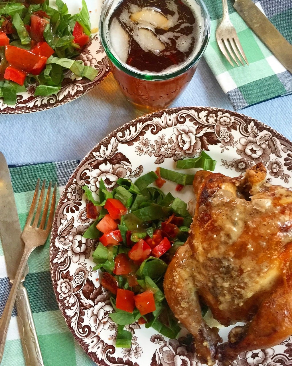 a fully cooked chicken with a salad on a plate