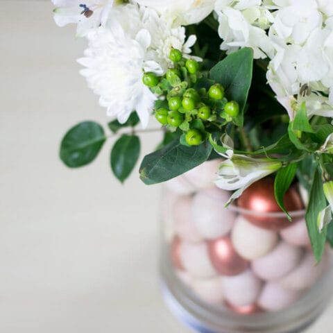 a diy center piece with copper painted eggs and flowers.