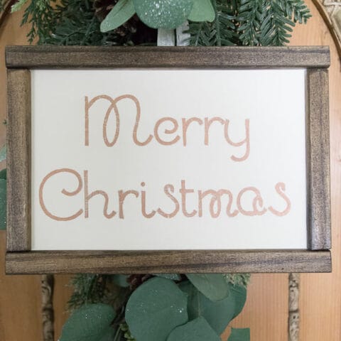 a diy Merry Christmas sign in a wooden frame