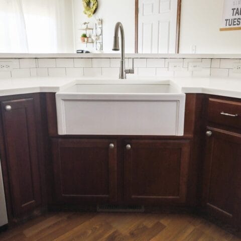 a white fireclay kitchen sink in a standard kitchen
