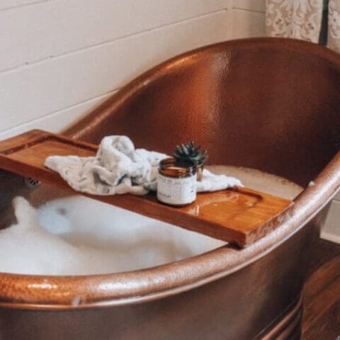 a copper tub with a diy tub tray