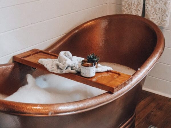 a copper tub with a diy tub tray