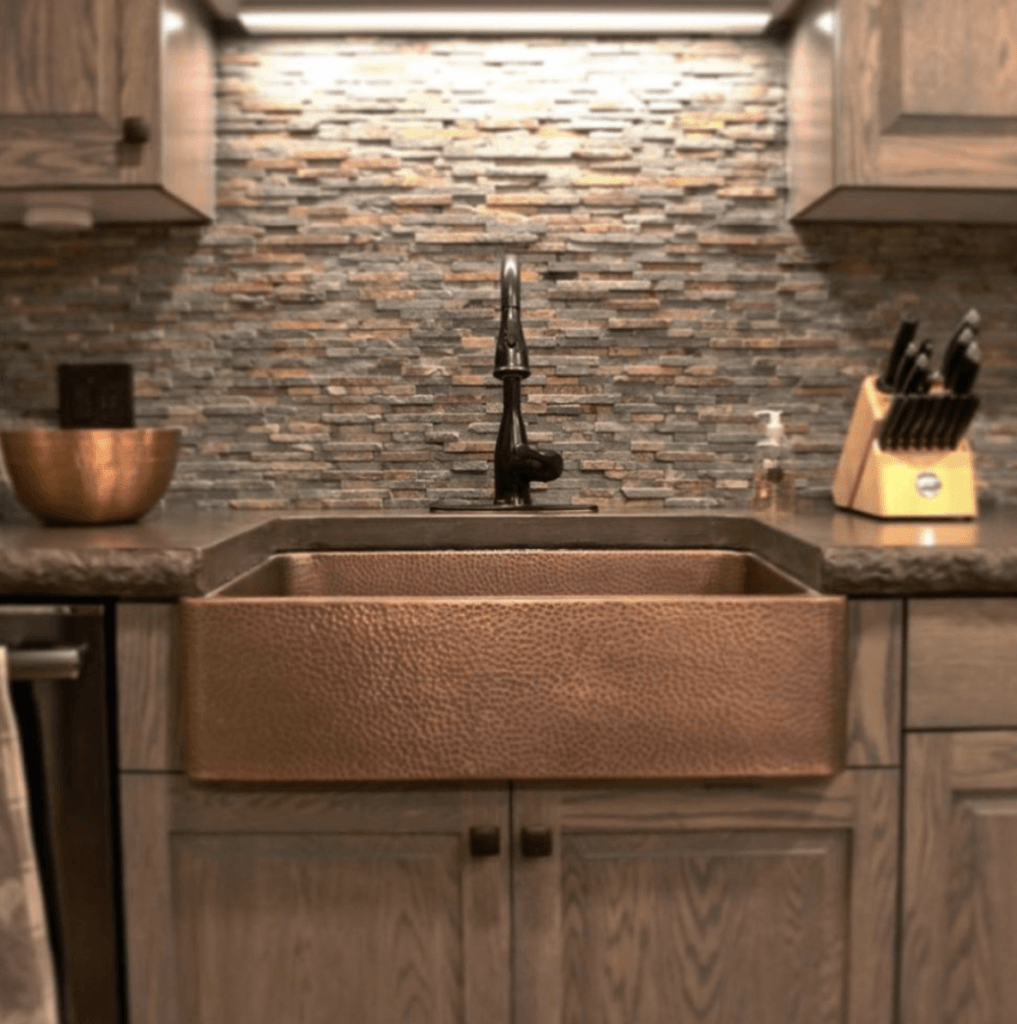 copper sink in dark kitchen