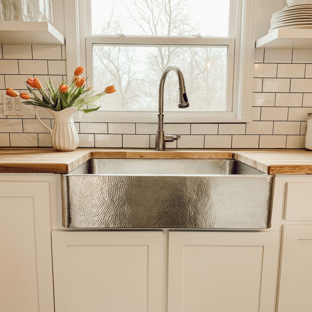 Crafted Stainless Steel Kitchen Sink with flowers in a vase on the countertop