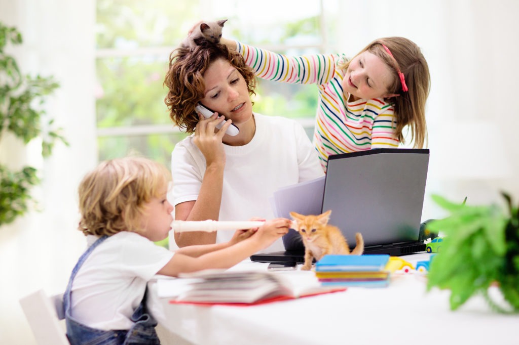 Mother working from home with kids during quarantine. 