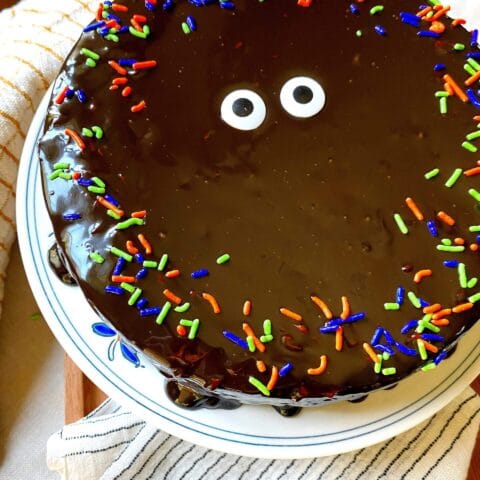 a black cake with sprinkles and eye candy