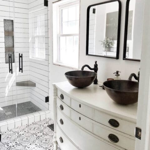 two copper vessel sinks in a white bathroom