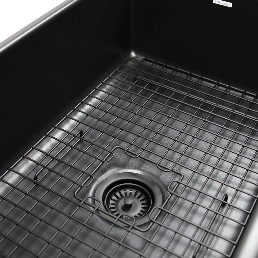 black sink with black grid and drain