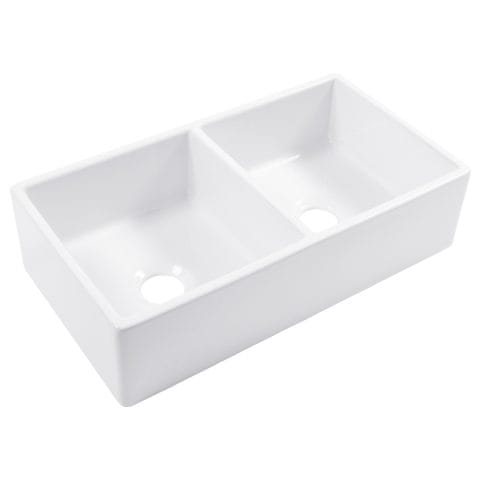 A double basin white fireclay farmhouse kitchen sink.