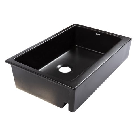 A matte black fireclay farmhouse kitchen sink.