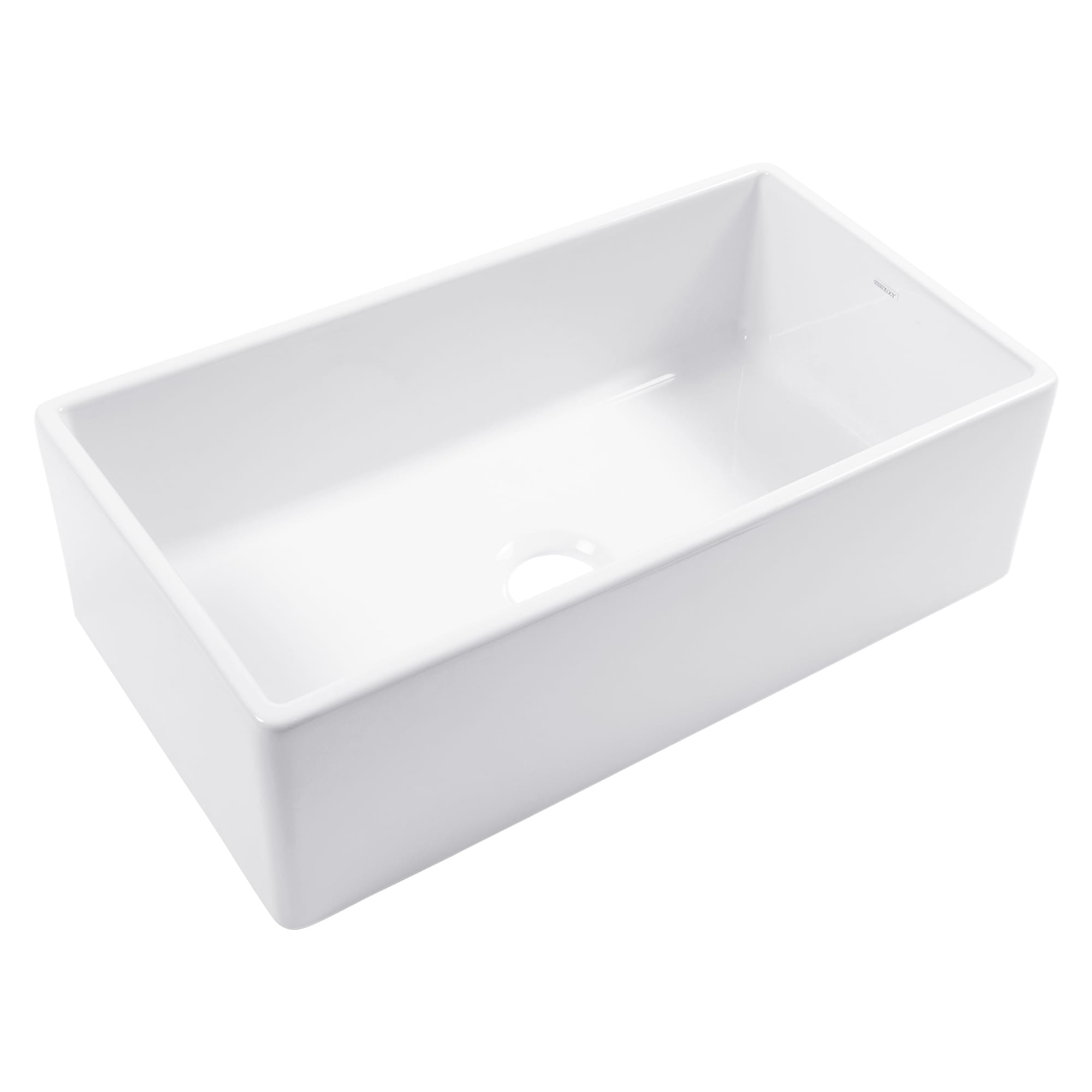 A white fireclay farmhouse kitchen sink.