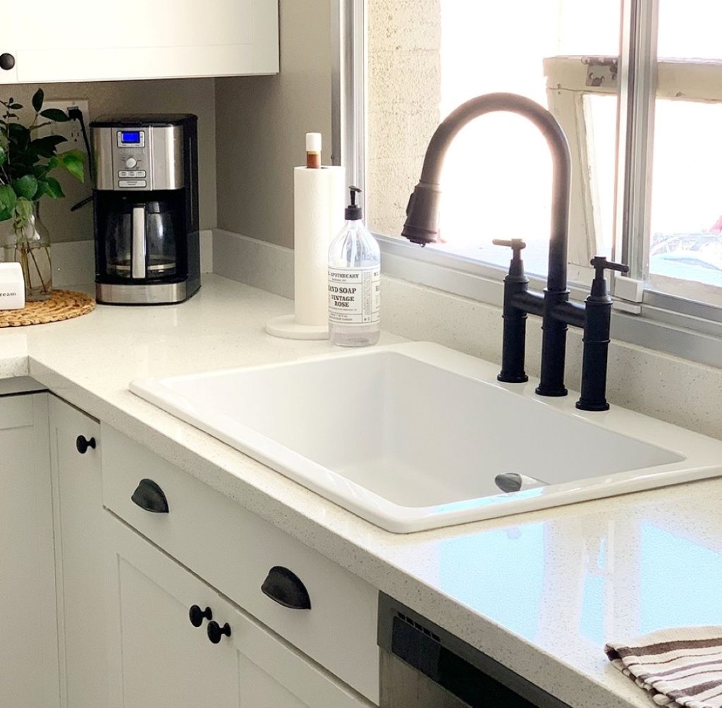 Jackson fireclay drop-in sink in white cabinets. 