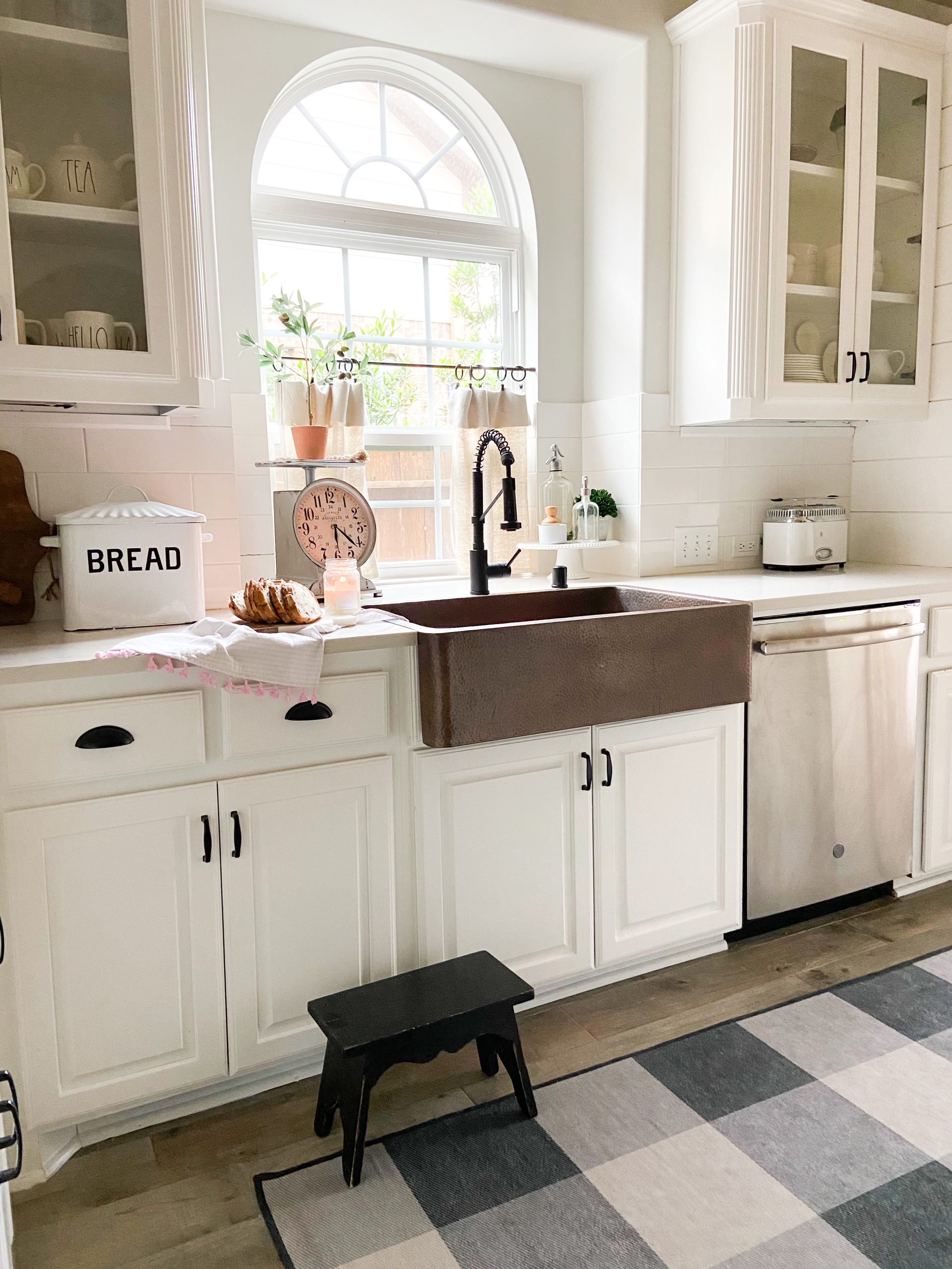 A copper rectangular undermount farmhouse sink in a clean modern farmhouse kitchen