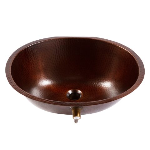 A shiny oval hand hammered undermount aged copper bath sink with a 1.5" drain hole and overflow spout.