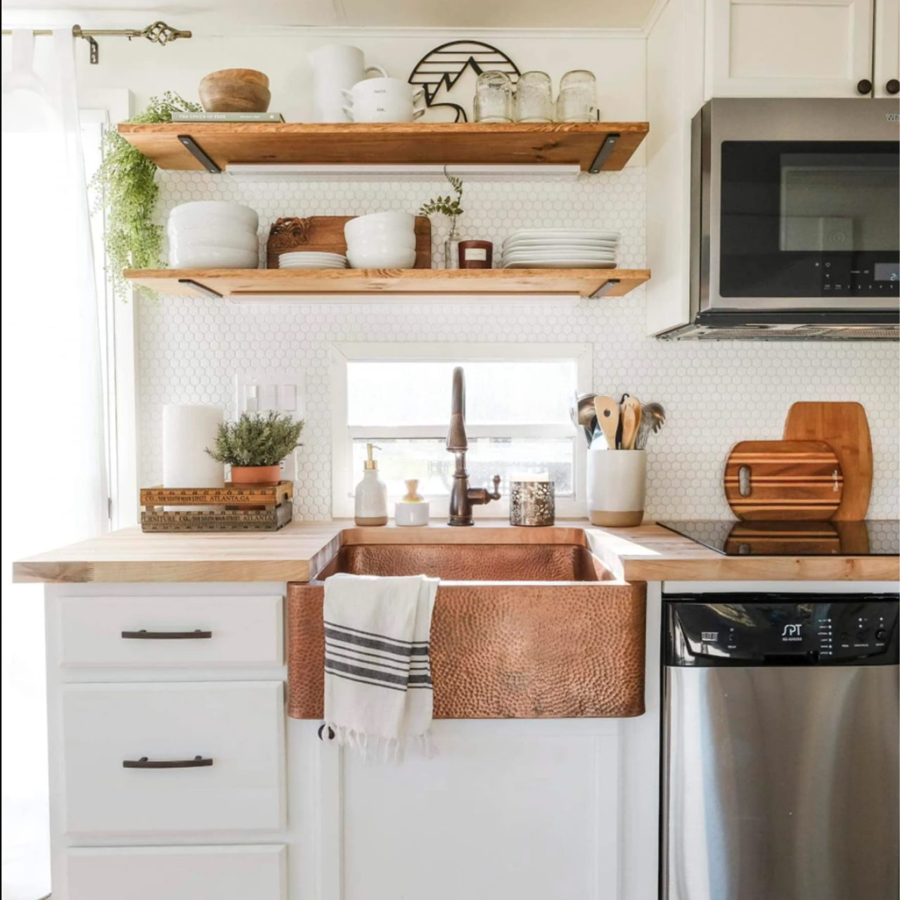 A copper rectangular undermount farmhouse sink in a modern farmhouse kitchen.