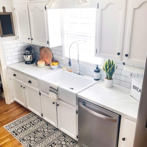 a white kitchen with a fireclay kitchen sink