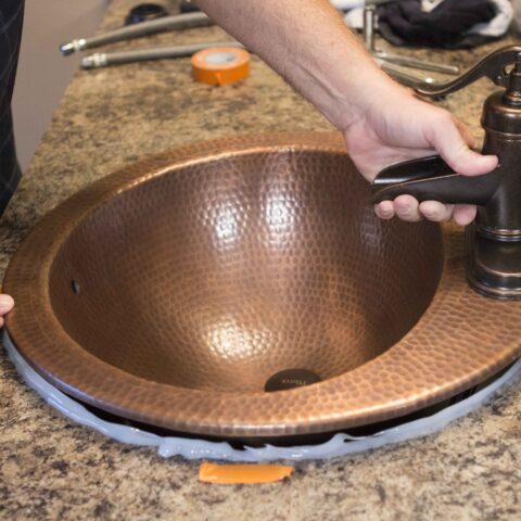 dropping sink onto caulk on countertop