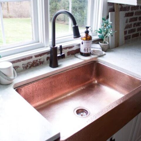 a shiny copper kitchen sink