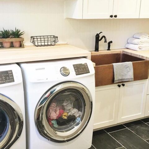 a laundry room with a copper sink
