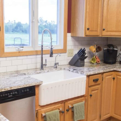 a white fireclay kitchen sink in a kitchen