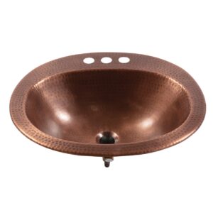 A hand hammered copper drop-in bath sink.