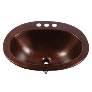 A hand hammered copper bathroom drop-in sink.