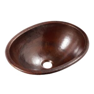 A hand hammered dual mount copper bathroom sink.