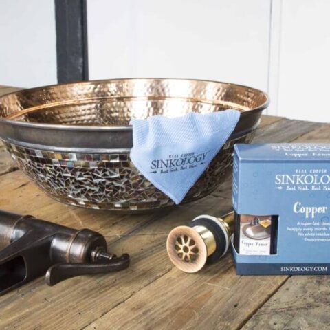 a copper vessel sink with mosaic glass