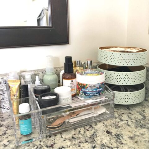 bathroom items organized in a container on a bathroom countertop