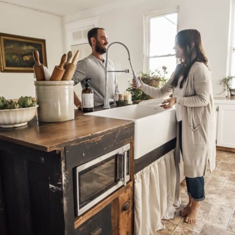 a husband and wife in the kitchen