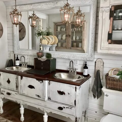 a farmhouse style bathroom with two nickel sinks
