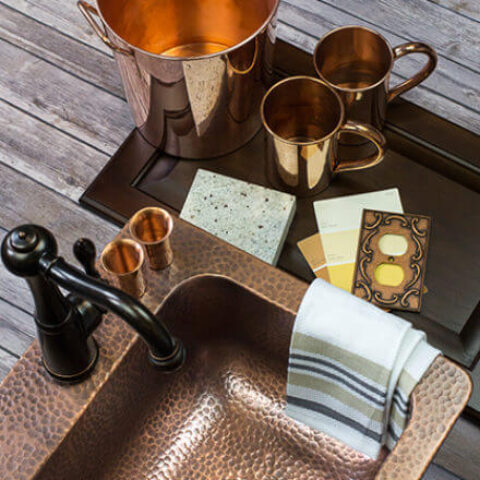 a copper sink with copper decor items