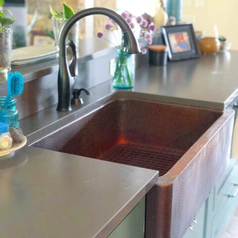 a copper farmhouse kitchen sink