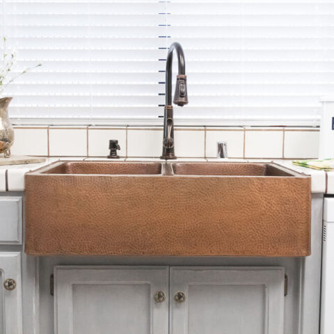 a farmhouse copper kitchen sink