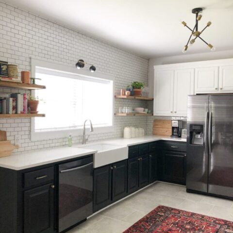 a renovated kitchen with a fireclay kitchen sink and white tile backsplash