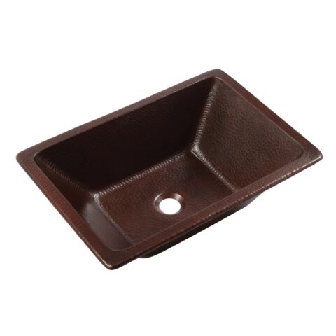 A hand hammered copper dual mount bathroom sink.