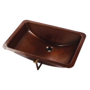 A hand hammered copper undermount bathroom sink.
