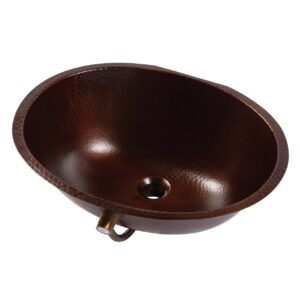 A hand hammered copper undermount bathroom sink.