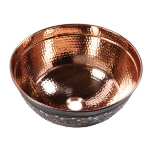 A hand hammered copper vessel bathroom sink.