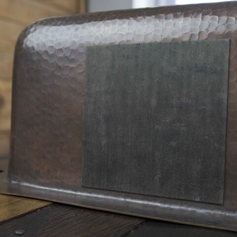 kitchen sink sound dampening pad on the side of a sink