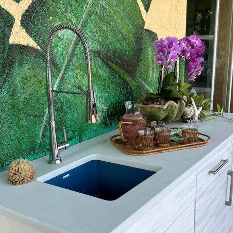 A matte blue square undermount bar and prep sink made in fireclay installed outside bar.