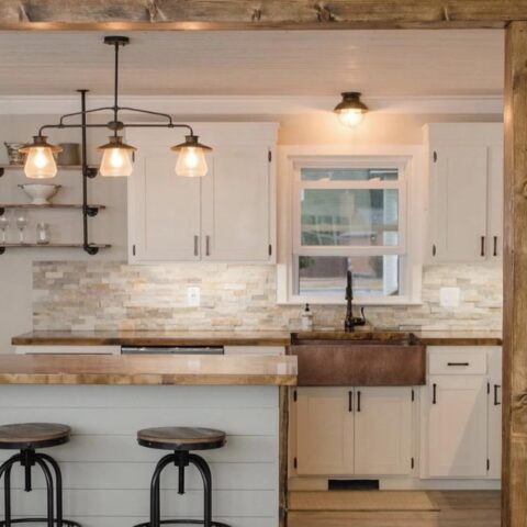 a kitchen with a copper farmhouse sink