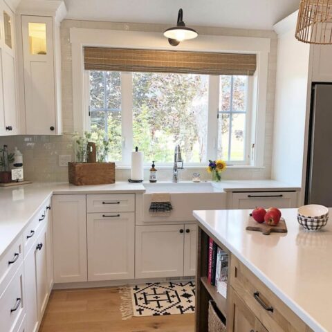 a white fireclay kitchen sink in a traditional white clean kitchen
