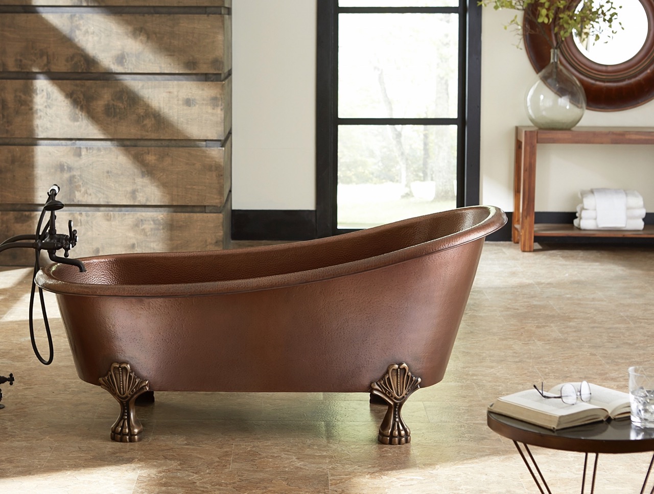 A hand hammered copper claw foot bath tub