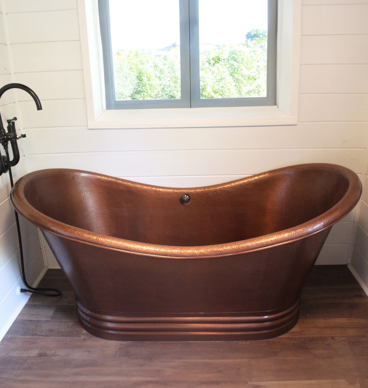 A hand hammered copper bath tub.