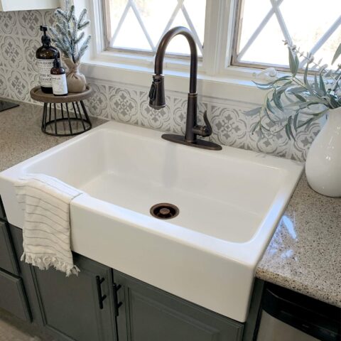 a white fireclay kitchen sink